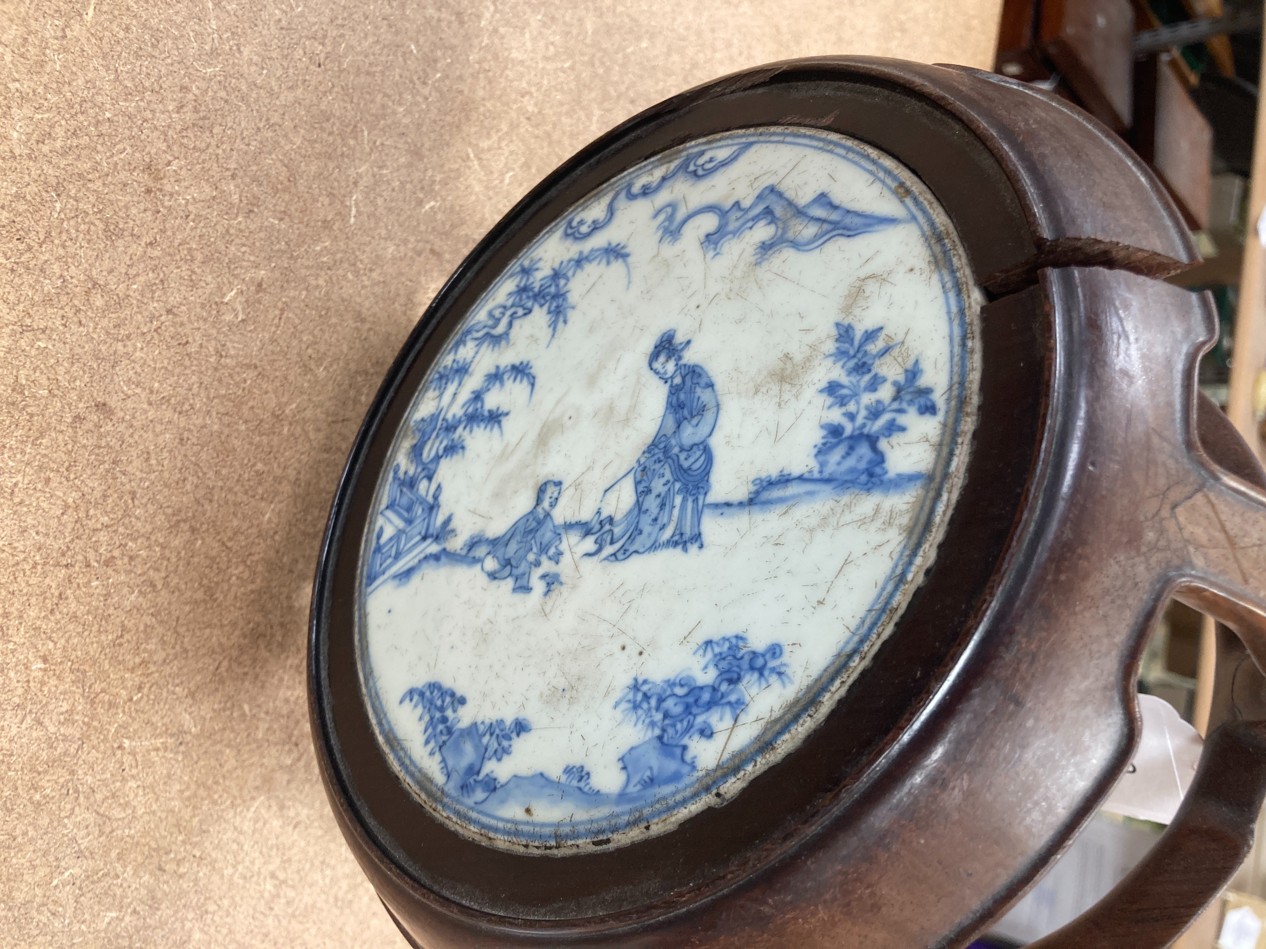 A 19th century Chinese blue and white circular tile inset hongmu stand, 22cm